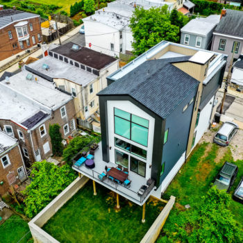 An aerial view of a house in a neighborhood.
