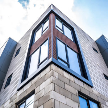 An apartment building with windows on the side.