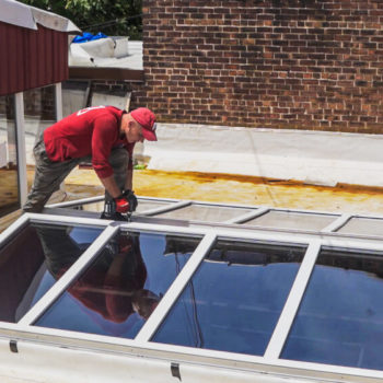 A man installing a solar roof on a roof.