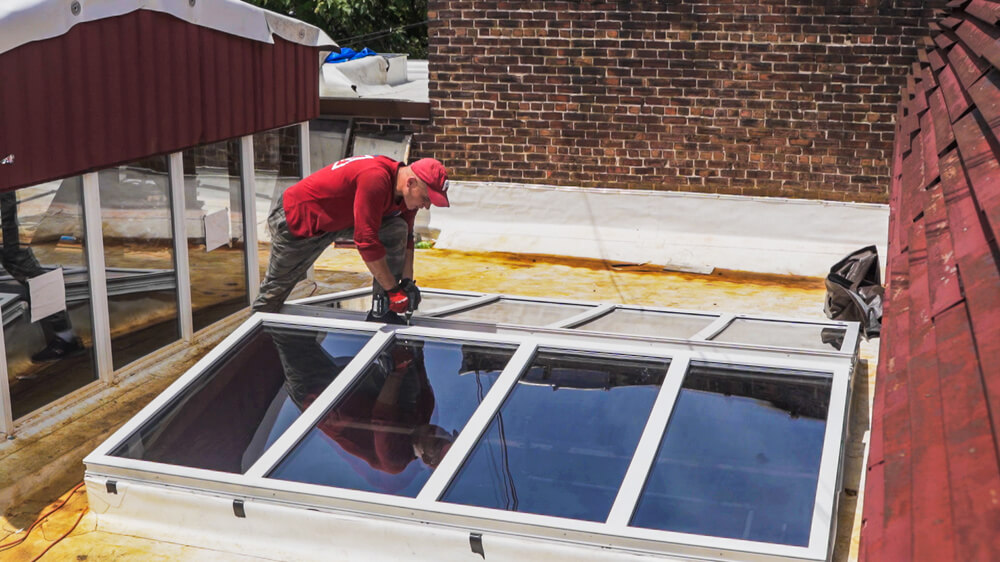 A man installing a solar roof on a roof.