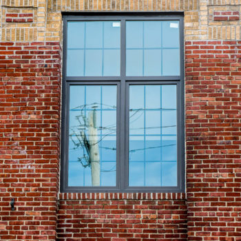 A red brick building with a window in it.