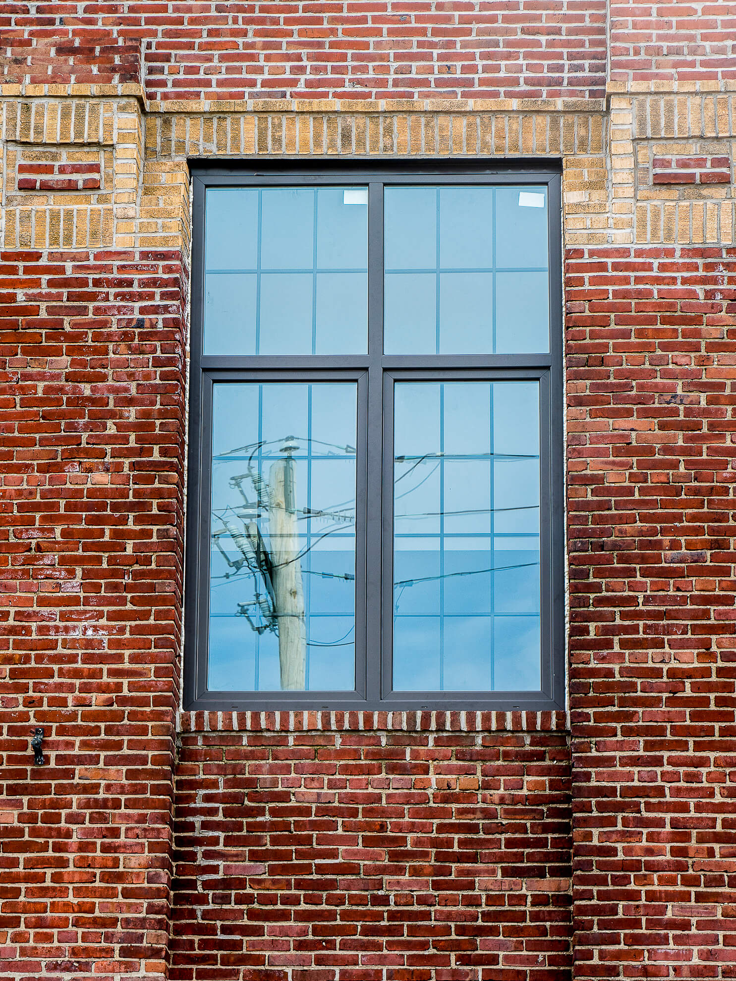 A red brick building with a window in it.