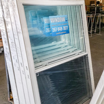 A warehouse full of windows that are on pallets.