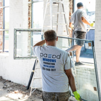 A man standing in front of a window.