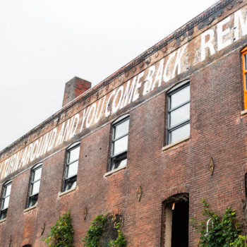 A brick building with a sign on it.