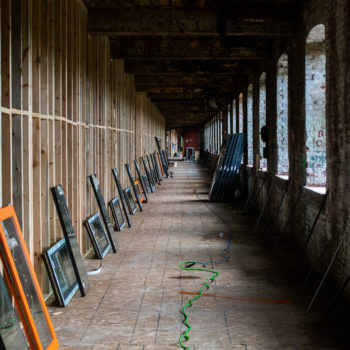 A long hallway with a row of frames.