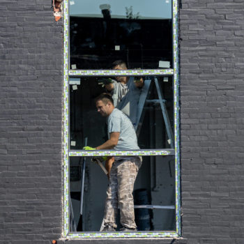 A group of men standing in a window.